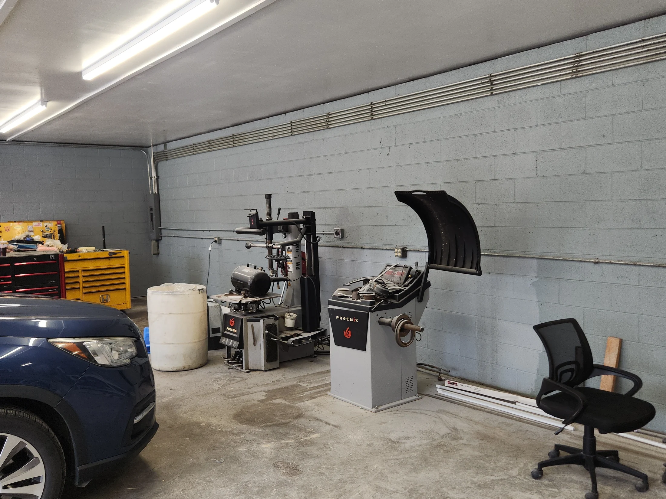 Tire changing and wheel balancing equipment inside the Stepp's service bay